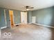 A spacious bedroom with a ceiling fan and neutral carpeting is move-in ready at 2029 W 60Th St, Indianapolis, IN 46228