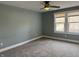Bedroom with neutral carpet, a ceiling fan, and two sun-filled windows at 2029 W 60Th St, Indianapolis, IN 46228