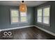 Bedroom with dark hardwood floors and a chandelier featuring lots of natural light at 2029 W 60Th St, Indianapolis, IN 46228