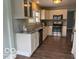 Bright kitchen features stainless steel appliances, granite countertops, and wood-look flooring at 2029 W 60Th St, Indianapolis, IN 46228