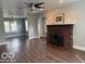 Spacious living room featuring hardwood floors and a decorative brick fireplace at 2029 W 60Th St, Indianapolis, IN 46228