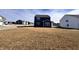 Rear view of home with blue siding and sunroom, set against a sunny sky at 2322 Dixon Creek Dr, Whitestown, IN 46075
