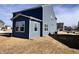 Side view of home's backyard and sunroom extension under a partly cloudy sky at 2322 Dixon Creek Dr, Whitestown, IN 46075