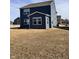 Angled rear view of home with blue siding and a sunroom addition at 2322 Dixon Creek Dr, Whitestown, IN 46075
