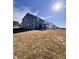 Back view of home with blue siding and back patio, under a blue sky at 2322 Dixon Creek Dr, Whitestown, IN 46075