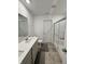 Contemporary bathroom with a spacious countertop, single sink and a sliding glass shower door at 2322 Dixon Creek Dr, Whitestown, IN 46075