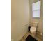 Compact bathroom featuring a toilet and window, offering functional space at 2322 Dixon Creek Dr, Whitestown, IN 46075