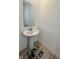 Bathroom featuring a pedestal sink and a decorative rug on the light wooden floor at 2322 Dixon Creek Dr, Whitestown, IN 46075