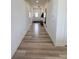 Long hallway featuring wood floors, white walls, and several interior doors at 2322 Dixon Creek Dr, Whitestown, IN 46075