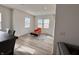 Bright living area with lots of windows and a cozy seating area with a bright orange chair at 2322 Dixon Creek Dr, Whitestown, IN 46075
