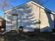 Side view of house showing light gray siding and small door at 3128 S Holt Rd, Indianapolis, IN 46221