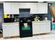 Kitchen with white cabinets and black appliances at 3128 S Holt Rd, Indianapolis, IN 46221