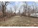 Large backyard with mature trees and unkempt grass at 3340 N Sherman Dr, Indianapolis, IN 46218