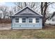 Newly renovated home with gray siding, blue accents and a landscaped yard at 3340 N Sherman Dr, Indianapolis, IN 46218