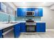 Stylish kitchen, blue cabinets, marble counters, and tile backsplash at 3340 N Sherman Dr, Indianapolis, IN 46218