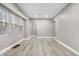 Spacious living room with light gray walls and vinyl plank flooring at 3340 N Sherman Dr, Indianapolis, IN 46218