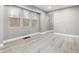 Spacious living room with light gray walls and vinyl plank flooring at 3340 N Sherman Dr, Indianapolis, IN 46218
