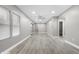 Spacious living room with light gray walls and vinyl plank flooring at 3340 N Sherman Dr, Indianapolis, IN 46218