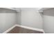 Empty storage closet with white shelves and grey walls at 3340 N Sherman Dr, Indianapolis, IN 46218
