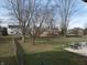 Large fenced backyard featuring trees and a patio area with outdoor seating for relaxation and entertaining at 3656 Homestead E Cir, Plainfield, IN 46168