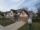Well-maintained two-story home with a two-car garage, blue front door, and a beautifully landscaped yard at 3656 Homestead E Cir, Plainfield, IN 46168