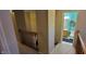 Bright hallway leading to a quaint bathroom with blue accents and fresh towels at 3656 Homestead E Cir, Plainfield, IN 46168