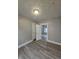 Simple bedroom with hardwood floors and access to other rooms at 4041 Boulevard Pl, Indianapolis, IN 46208