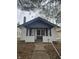 Charming bungalow with black and white exterior, front porch, and well-maintained landscaping at 4041 Boulevard Pl, Indianapolis, IN 46208