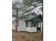 Side view of a charming bungalow showcasing its white siding and black accents at 4041 Boulevard Pl, Indianapolis, IN 46208