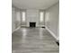 Spacious living room featuring hardwood floors and a fireplace at 4041 Boulevard Pl, Indianapolis, IN 46208
