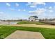 New construction home with a pond view, fresh grass, and clear blue skies at 4171 Douro Trl, Westfield, IN 46062