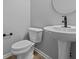 Stylish powder room featuring a sleek pedestal sink and modern fixtures, offering convenience and elegance for guests at 4171 Douro Trl, Westfield, IN 46062