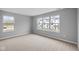 Well-lit bedroom featuring large windows with views of neighboring homes and neutral-toned walls at 4171 Douro Trl, Westfield, IN 46062