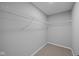 Walk-in closet with carpeted floor and wire shelving for organized storage at 4171 Douro Trl, Westfield, IN 46062