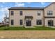 Exterior of a home featuring beige siding, black trim, a small yard, and a covered patio at 4171 Douro Trl, Westfield, IN 46062