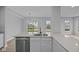 Modern kitchen features a quartz island, stainless appliances, and ample cabinetry at 4171 Douro Trl, Westfield, IN 46062