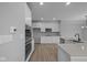 Modern kitchen design featuring stainless appliances, wood floors, and white cabinetry at 4171 Douro Trl, Westfield, IN 46062