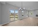 Open-concept living room features a sliding glass door and modern light fixture, perfect for entertaining and relaxation at 4171 Douro Trl, Westfield, IN 46062