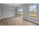 Living room with sliding doors to the outdoors, perfect for indoor-outdoor living, with a modern light fixture at 4171 Douro Trl, Westfield, IN 46062