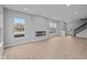 Spacious living room with an electric fireplace, large windows, and wood flooring at 4171 Douro Trl, Westfield, IN 46062