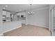 Open floor plan featuring modern light fixtures and stainless appliances at 4171 Douro Trl, Westfield, IN 46062