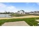A view of the backyard featuring a pond, green grass, and the rear of the home at 4195 Douro Trl, Westfield, IN 46062