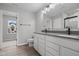 Bathroom featuring double vanity sinks, grey countertops, and modern black fixtures at 4195 Douro Trl, Westfield, IN 46062