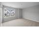 An empty bedroom with carpet flooring and a window showcasing the exterior of the property at 4195 Douro Trl, Westfield, IN 46062