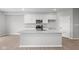 Bright, white kitchen featuring a large island with a sink and stainless steel appliances at 4195 Douro Trl, Westfield, IN 46062
