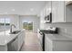 Bright, eat-in kitchen featuring quartz countertops, stainless appliances, and a sliding glass door at 4195 Douro Trl, Westfield, IN 46062