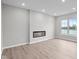 Modern living room featuring durable floors, a fireplace, and a large window with lake views at 4195 Douro Trl, Westfield, IN 46062