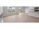 Bright living room featuring hardwood floors, modern appliances, a breakfast bar, and sliding glass doors at 4195 Douro Trl, Westfield, IN 46062