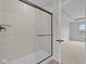 Modern bathroom with glass-enclosed shower and tiled walls at 4205 Douro Trl, Westfield, IN 46062