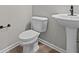 Bright bathroom featuring a toilet and pedestal sink at 4205 Douro Trl, Westfield, IN 46062